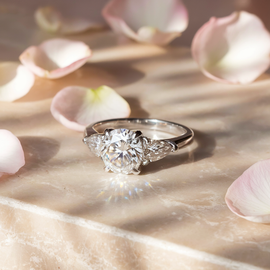 Classic Round Diamond Engagement Ring with Pear Shape Side Stones